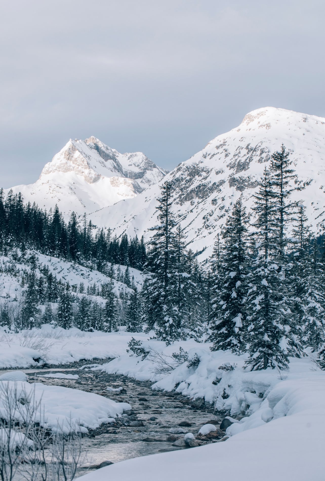 A snowy mountain scene with a river