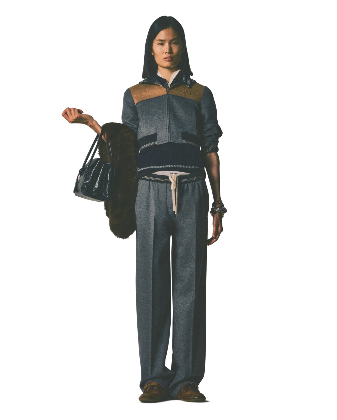 Miu Miu runway model with matching grey sweatshirt and pants set