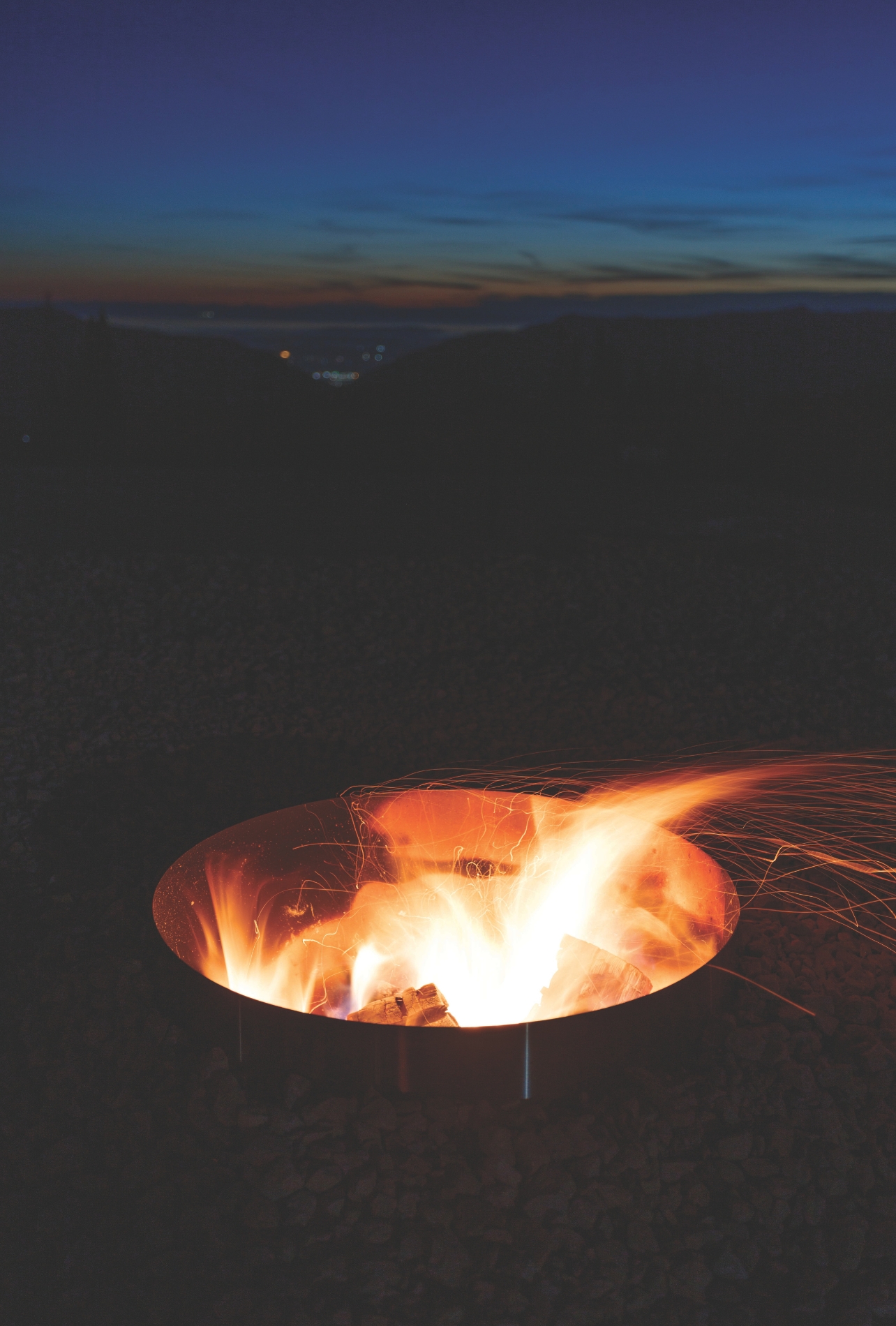An installation of a fire burning in a firepit outside