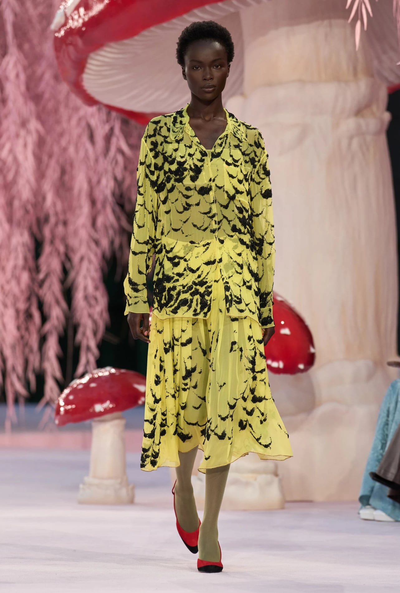 Chanel runway model wearing a black and yellow dress