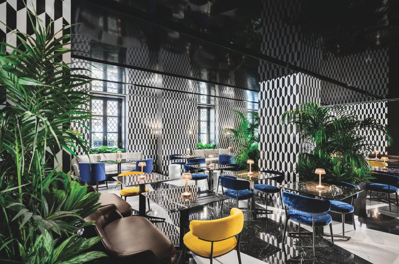 The Mandarin Oriental’s Mandarin Garden bar with accent furniture and tropical plants