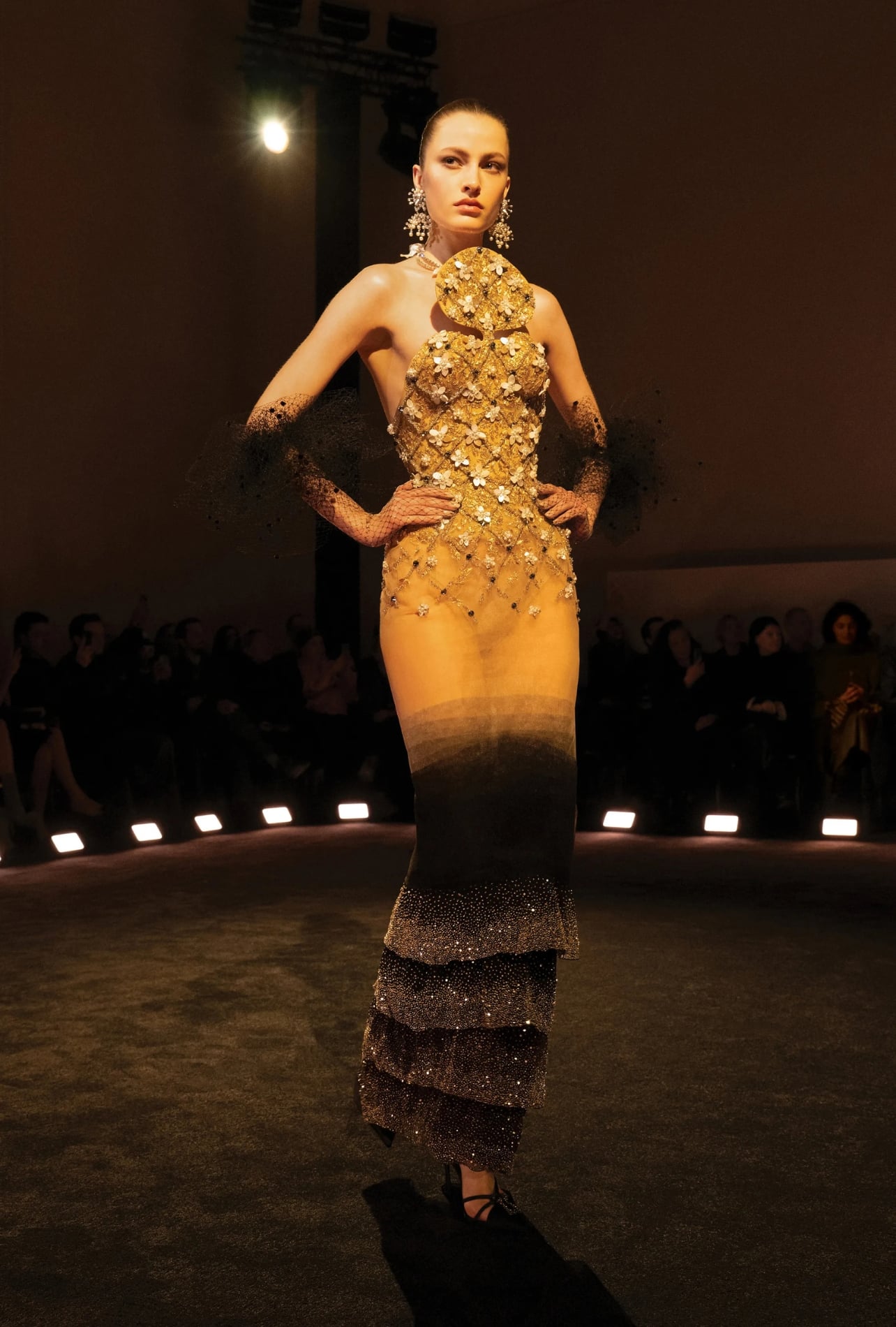 Schiaparelli runway model wearing an embellished form fitting dress