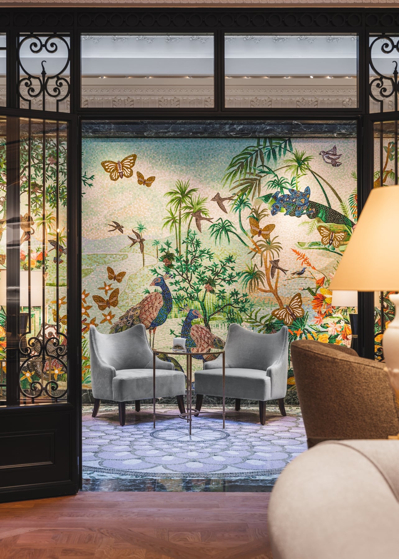 An elaborate mosaic mural with animals and plants inside the jardin d’hiver