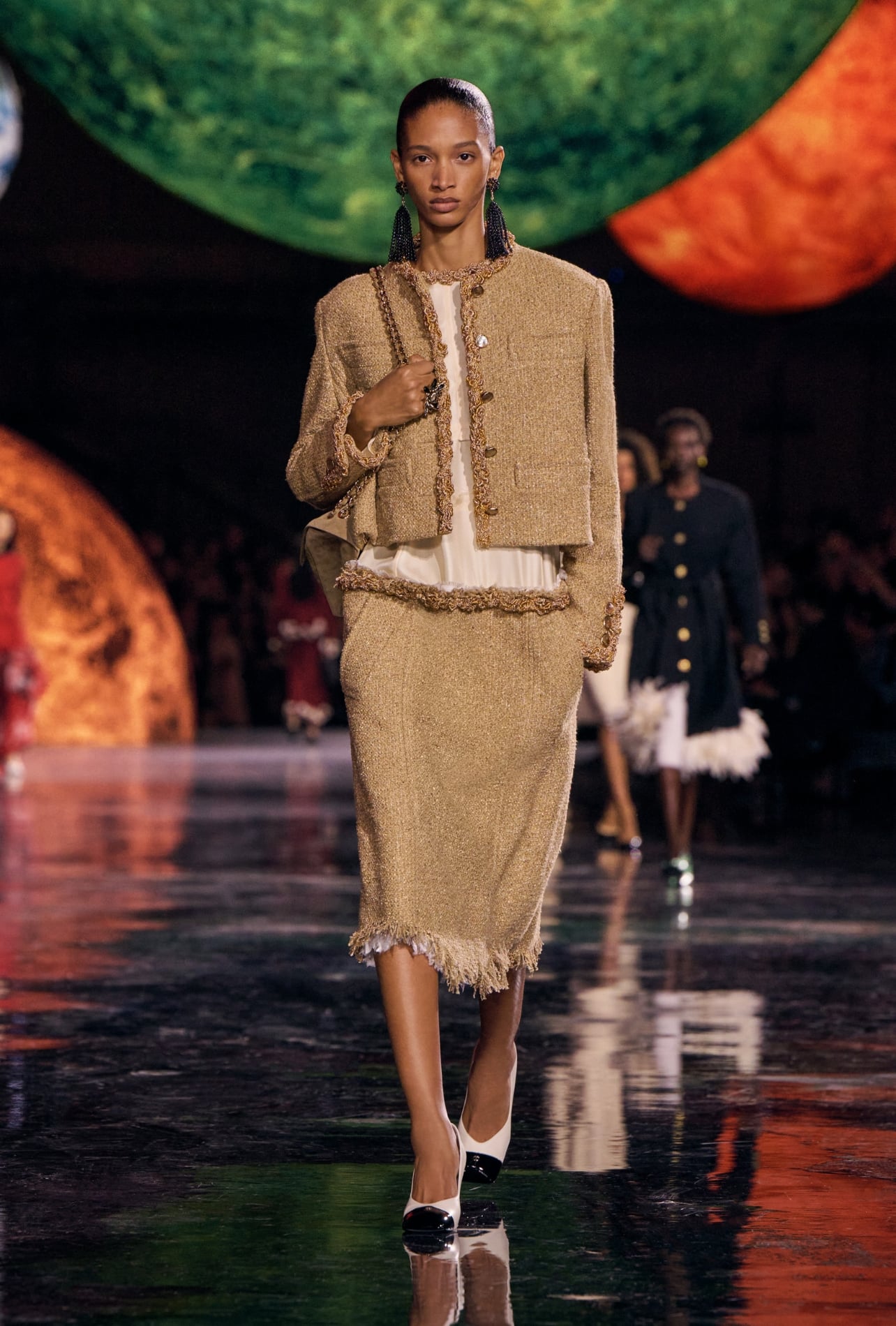 Chanel runway model wearing a brown top and skirt