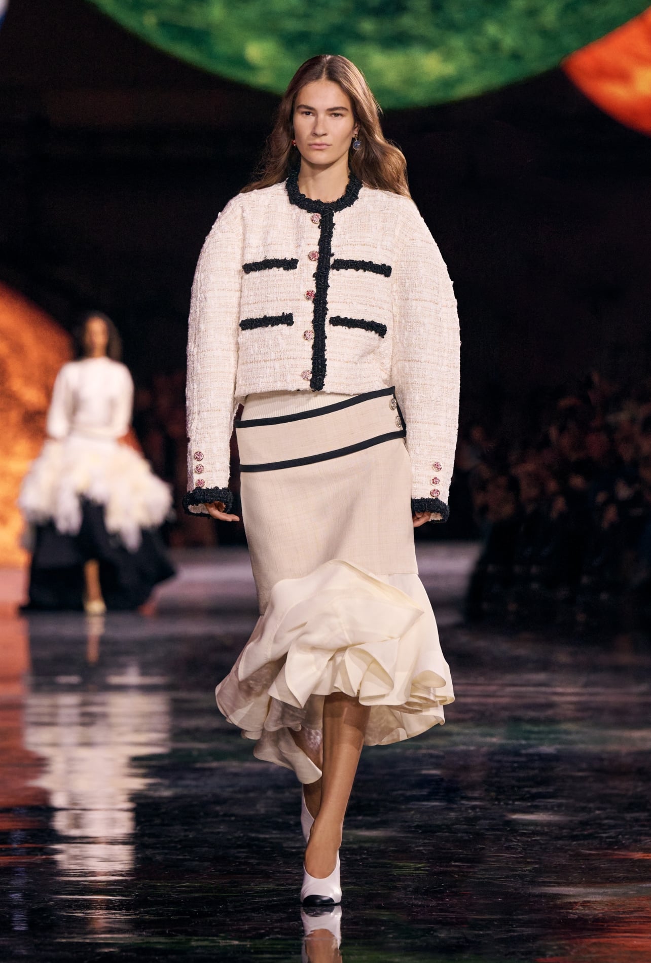 Chanel runway model wearing a cream top and skirt