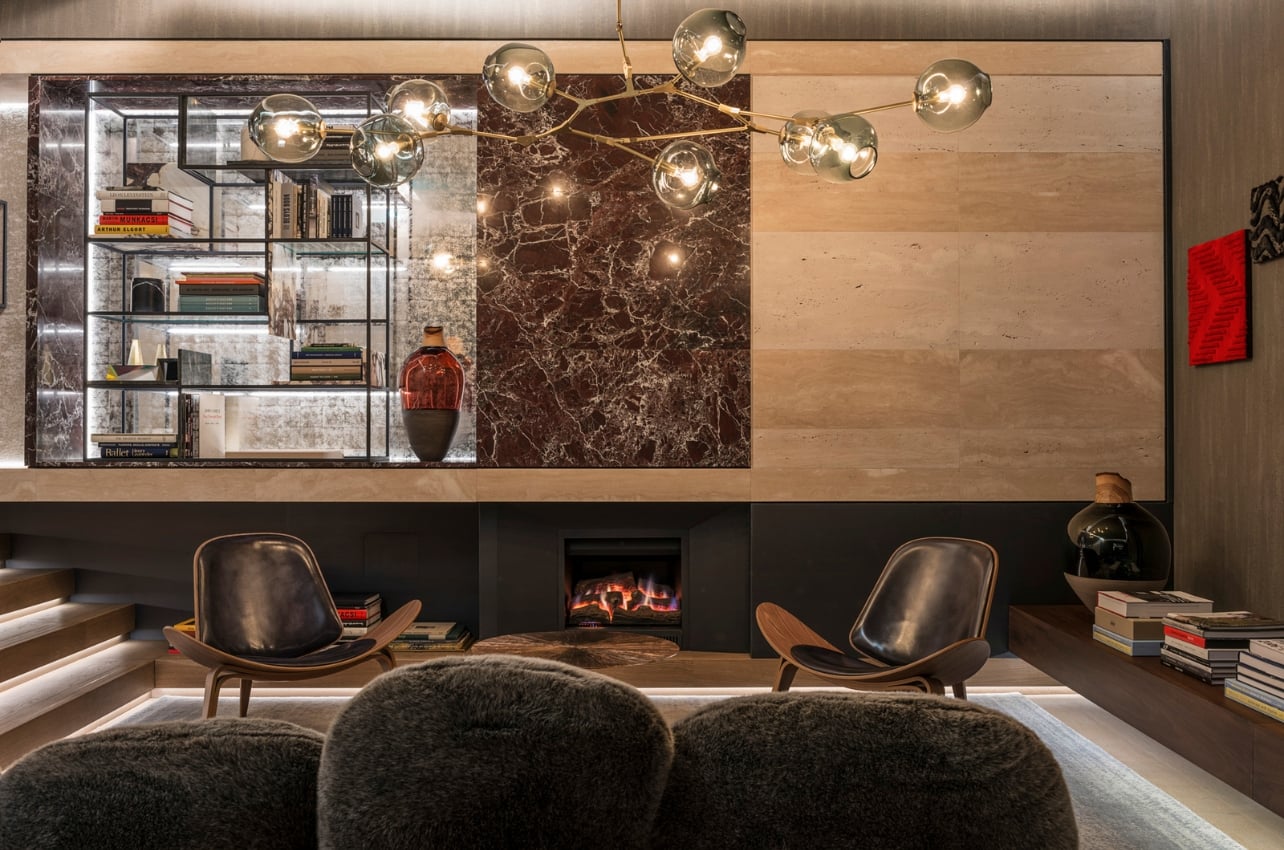 The residential-style foyer with a fireplace and seating at Fendi Private Suites