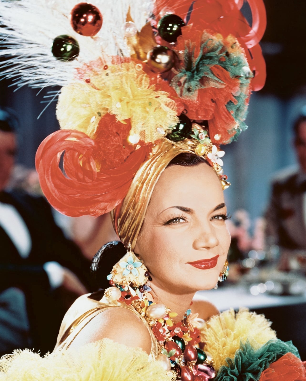 an actress wearing a headdress costume and big necklace