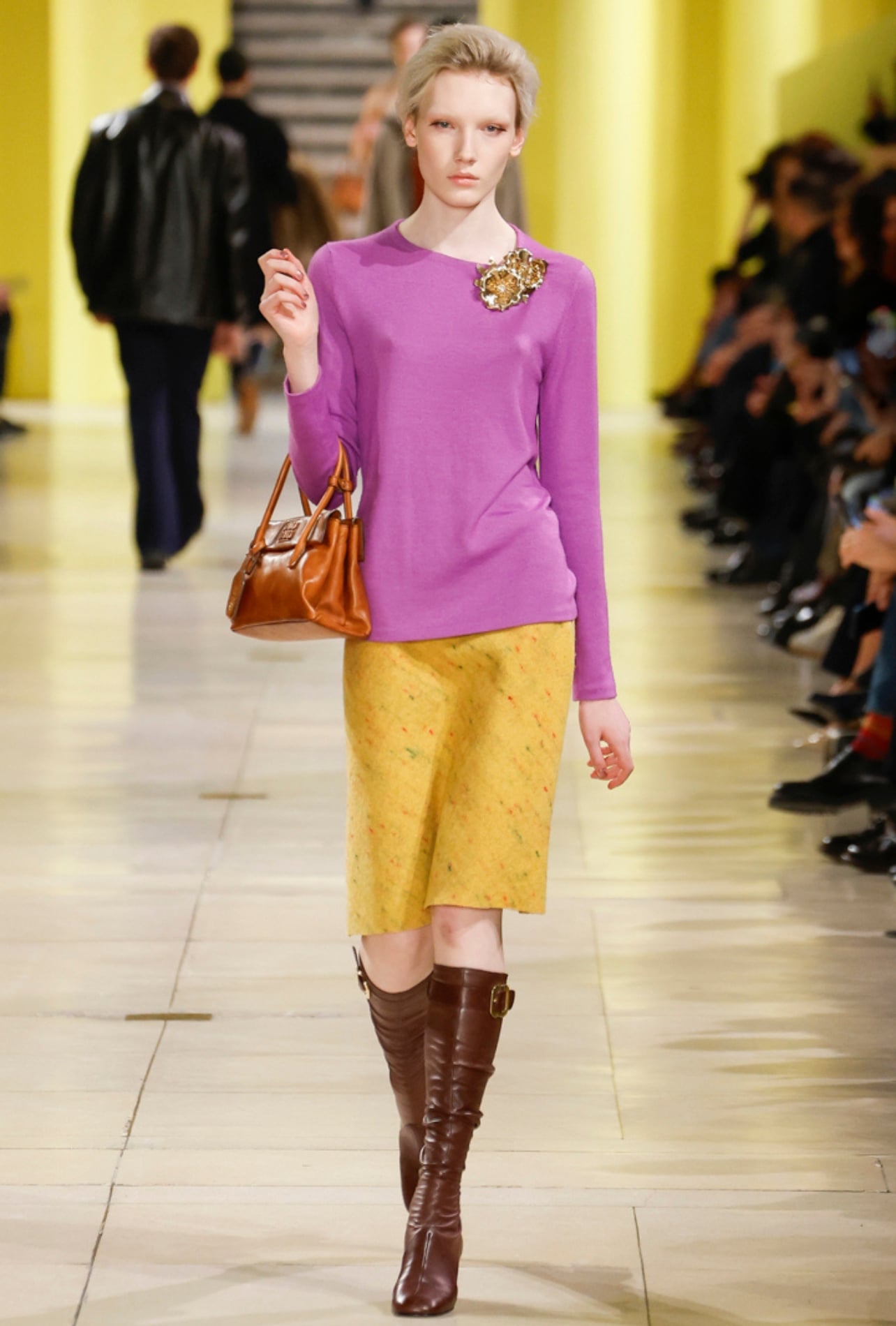 Miu Miu runway model wearing a pink top and yellow skirt