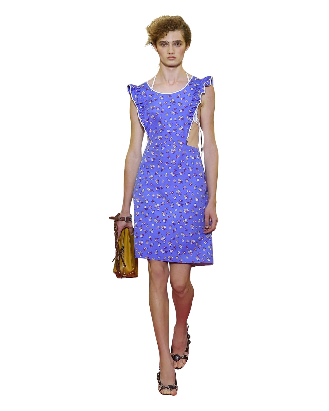 A Miu Miu runway model wearing a blue floral apron with ruffles