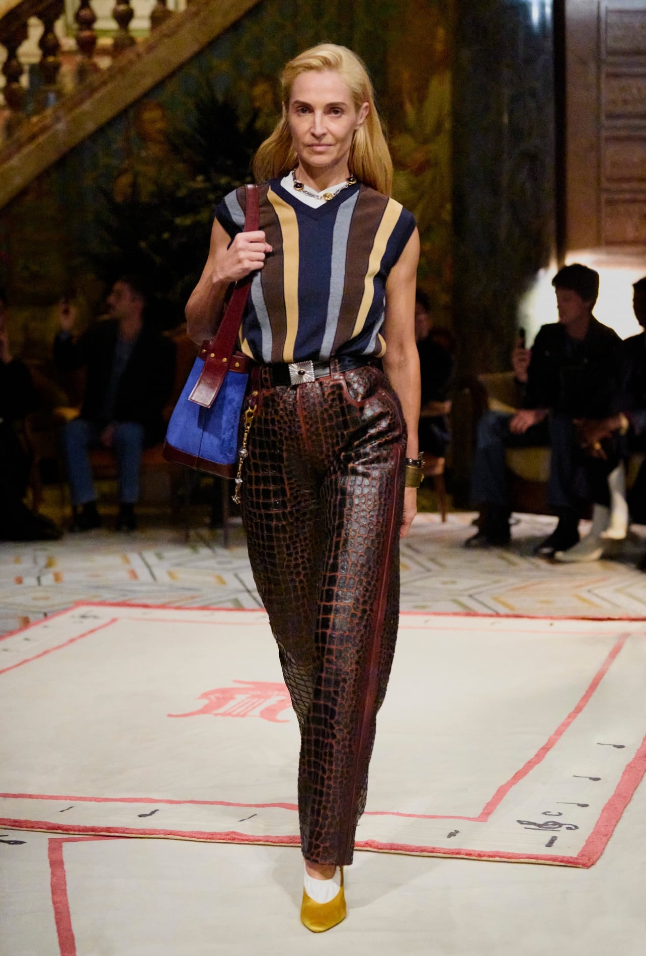 Versace runway model wearing a striped shirt and leather pants