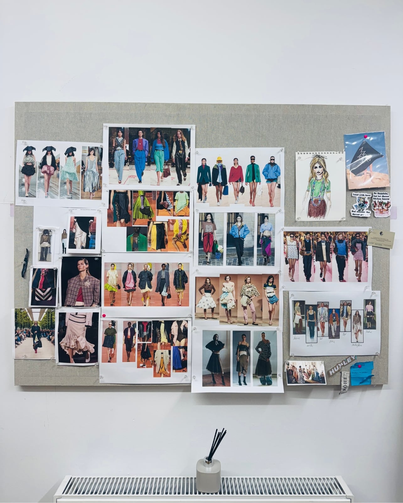A runway moodboard of fashion models posted on a wall