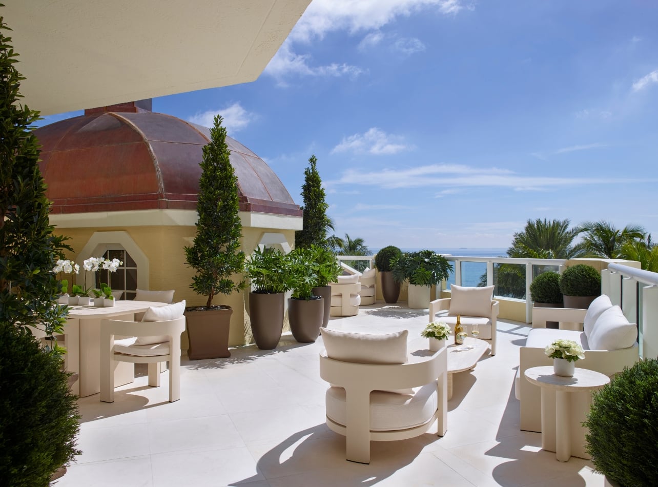 A large balcony with a seating area and an ocean view