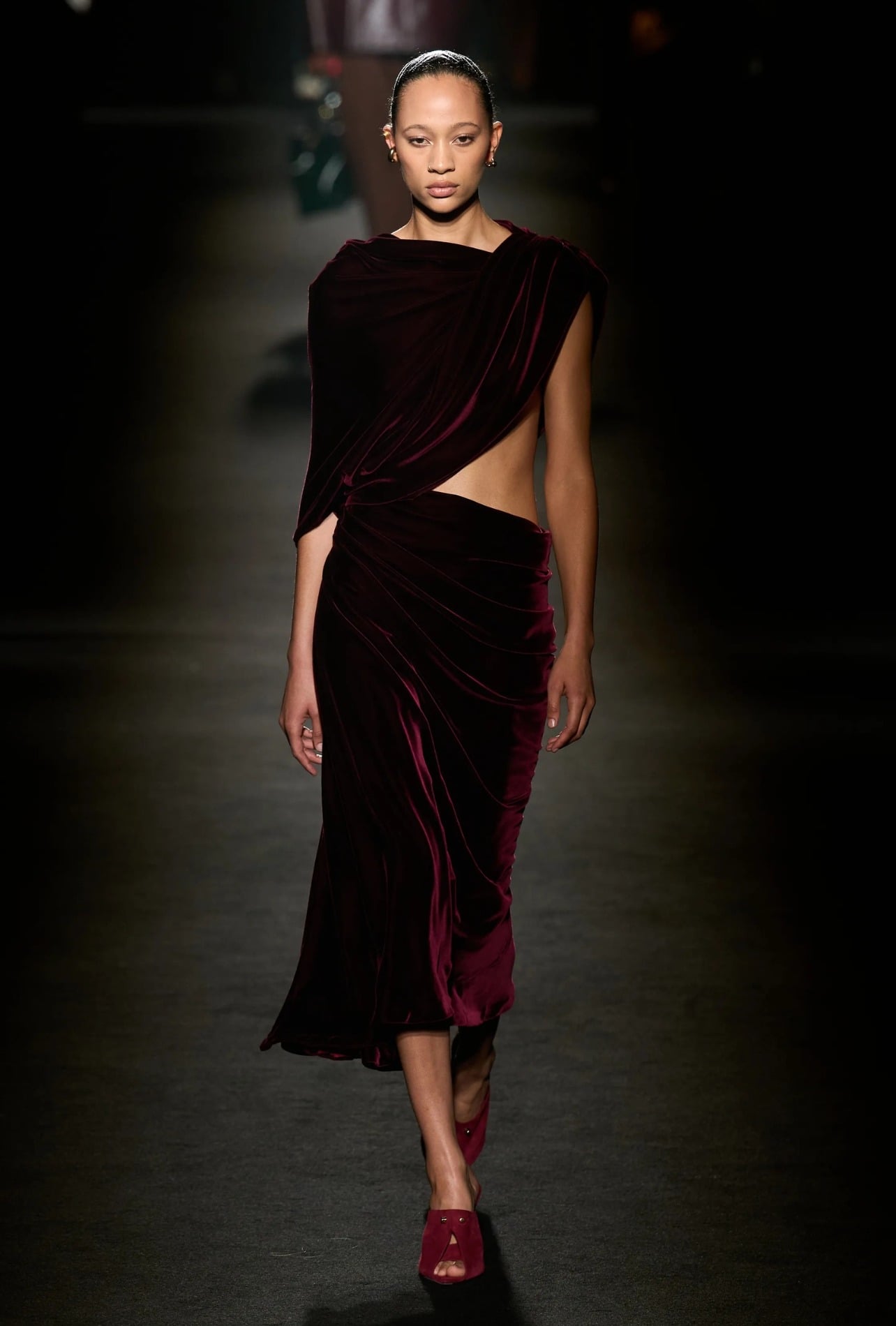 Balenciaga runway model wearing a red velvet dress