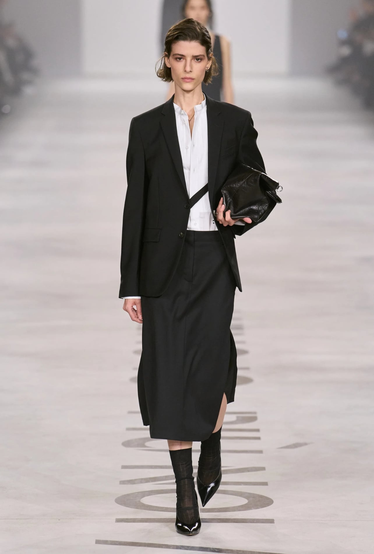 Fendi runway model wearing a black blazer and long skirt