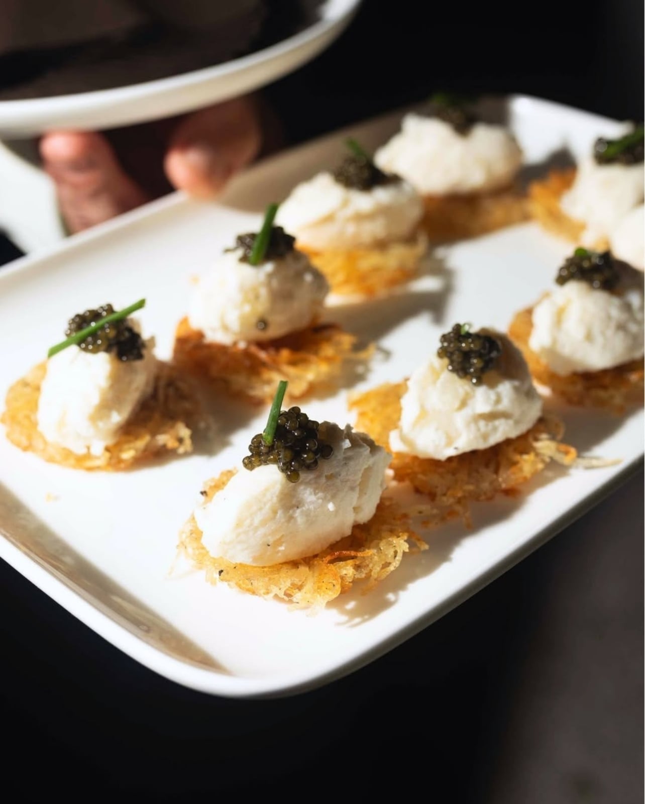 Crab on a cracker with caviar on a platter