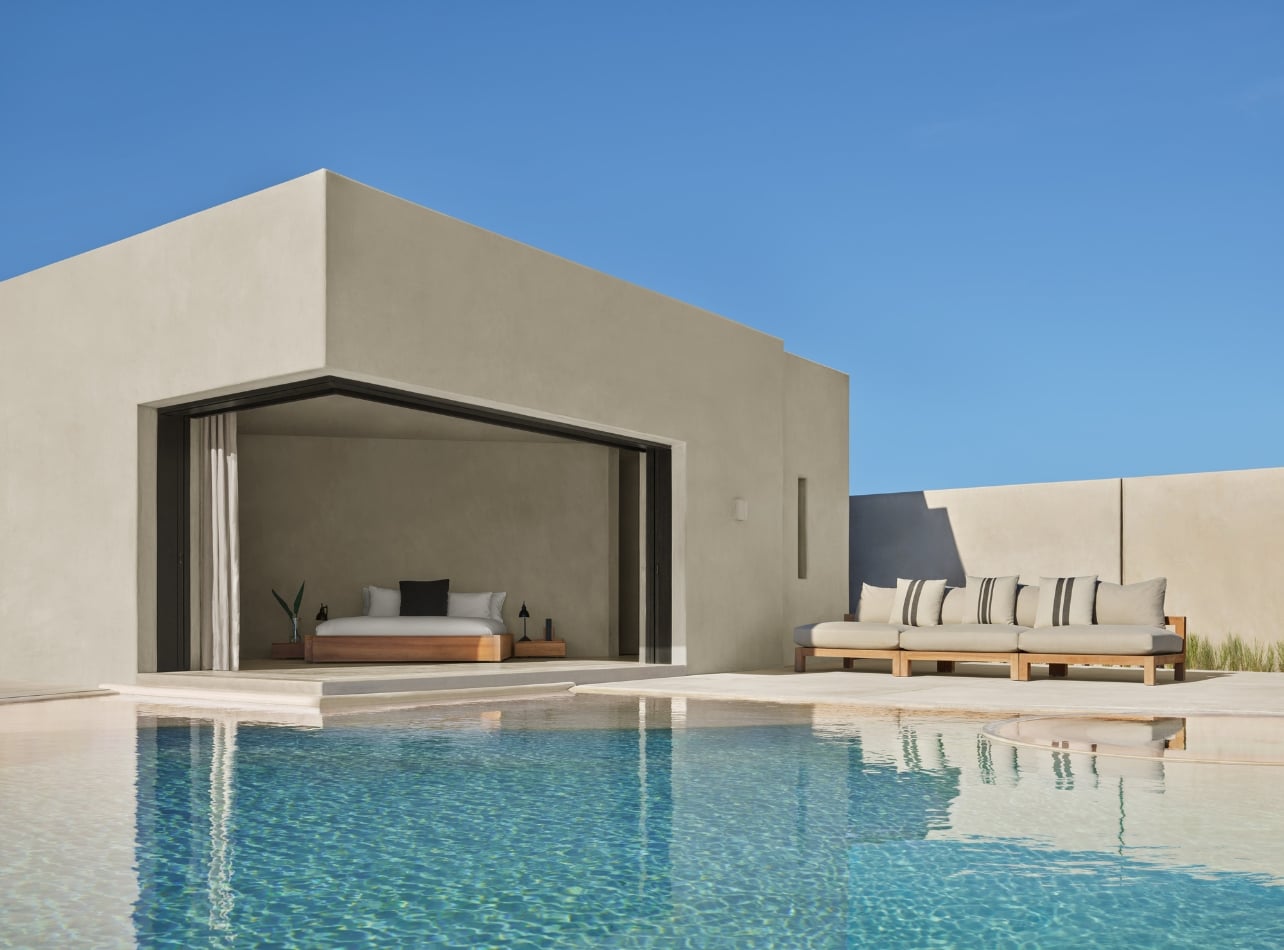 Interior of a pool with an open-air bedroom and couches