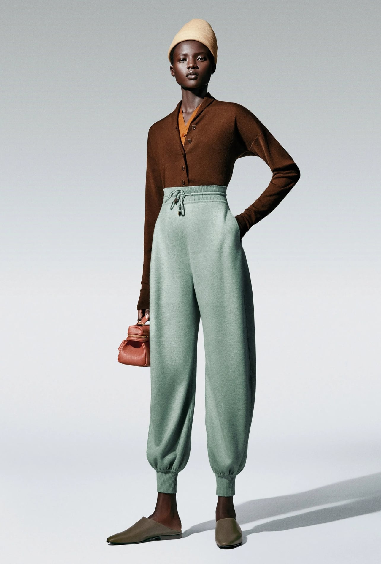 Loro Piana runway model wearing teal pants and a brown top