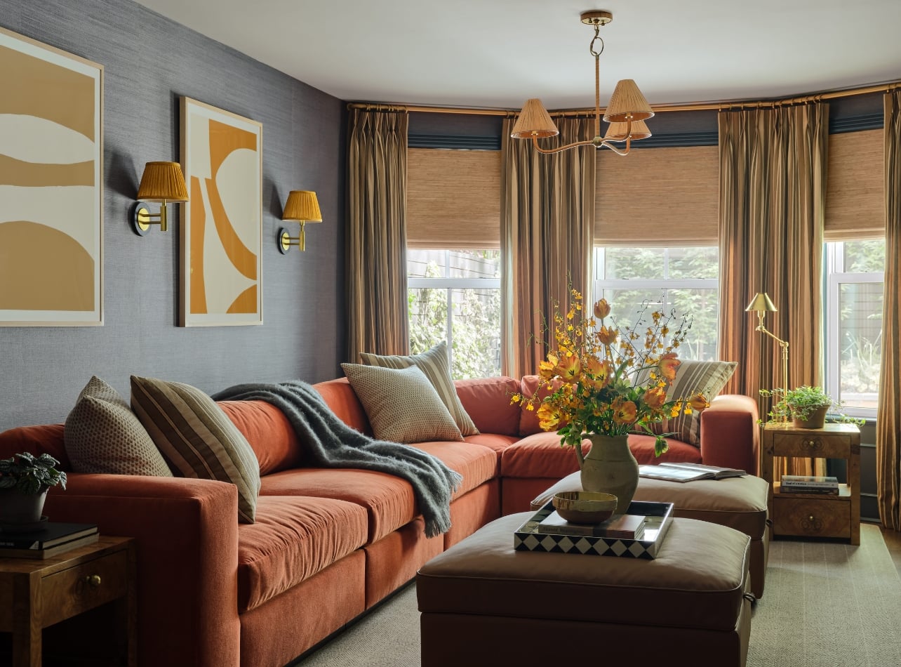 An interior of a living room with an orange couch from the book, The Happy Home