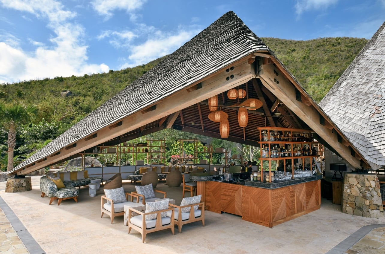 An open-air bar under a large wooden roof