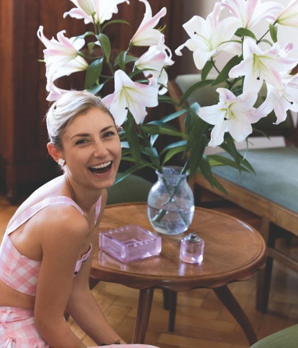 Portrait of author, Jenny Walton with a bouquet of lilies for her book, Jenny Sais Quoi