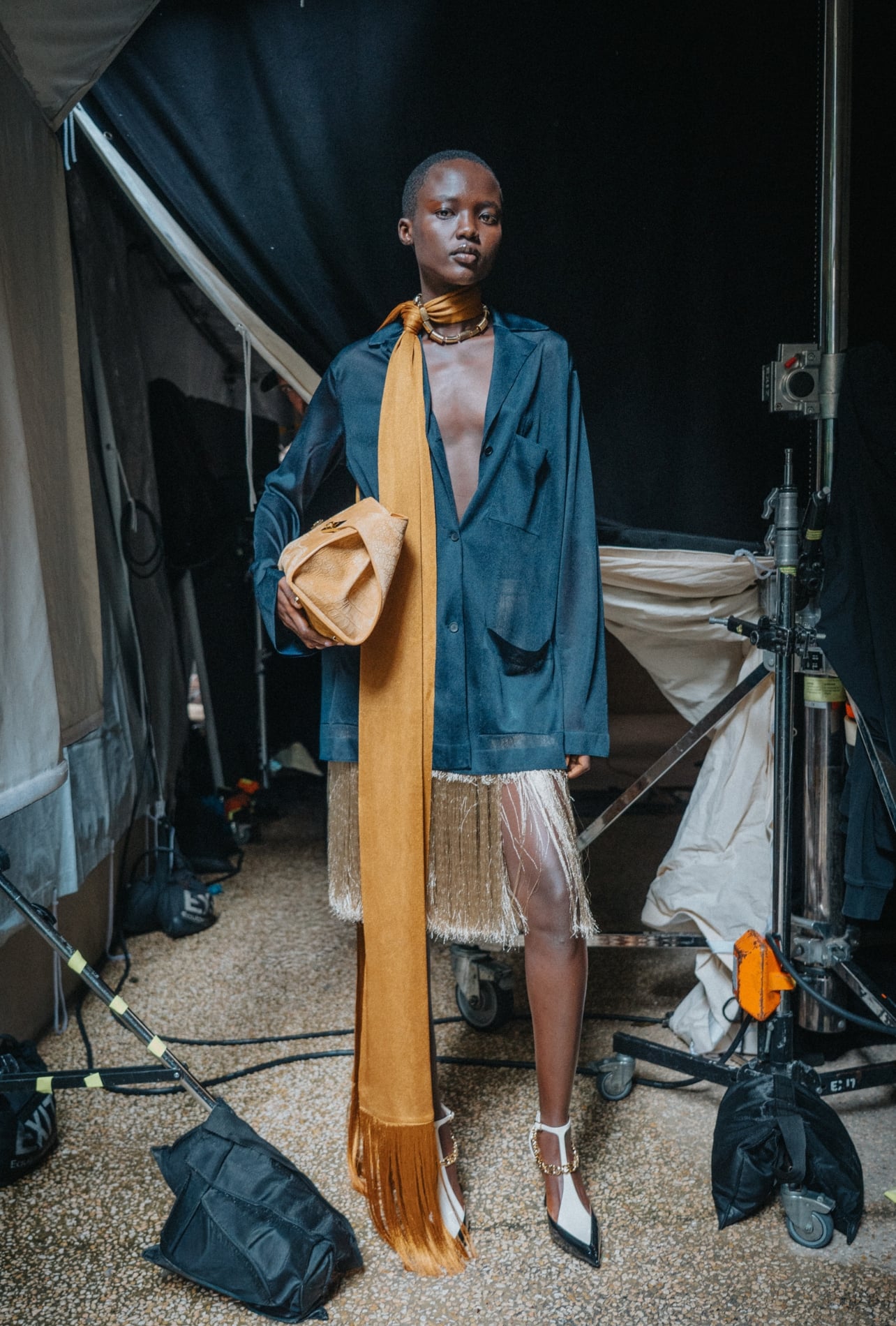 Ferragamo runway model wearing a blue blazer and a fringe dress