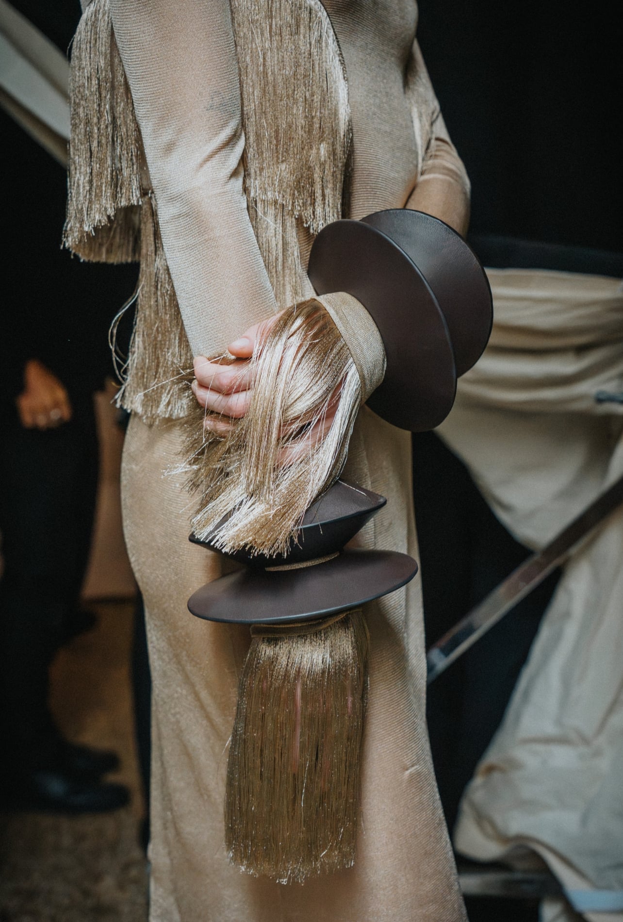 Ferragamo detail shot of a runway model wearing fringe sleeves