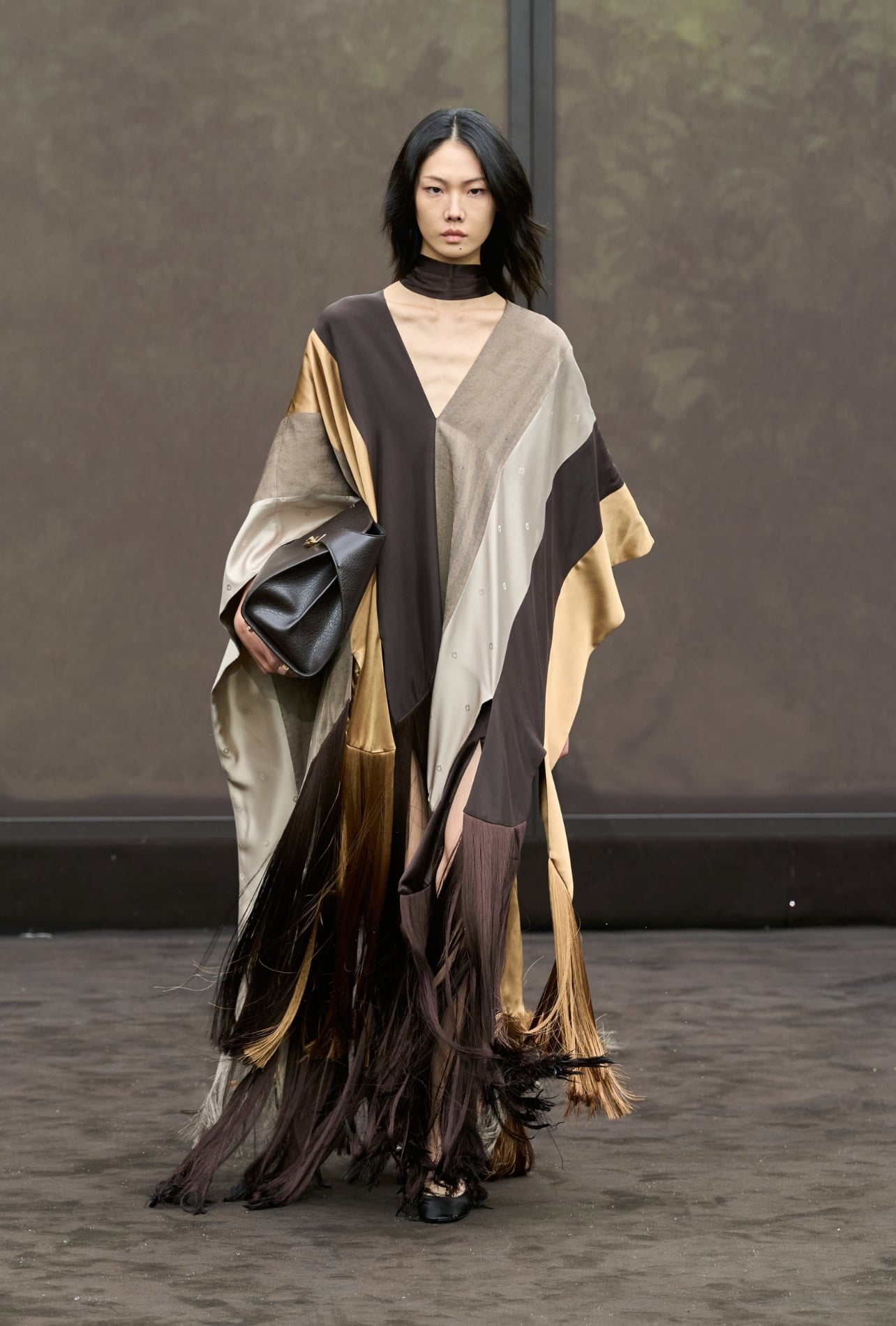 Ferragamo runway model wearing a striped flowy dress