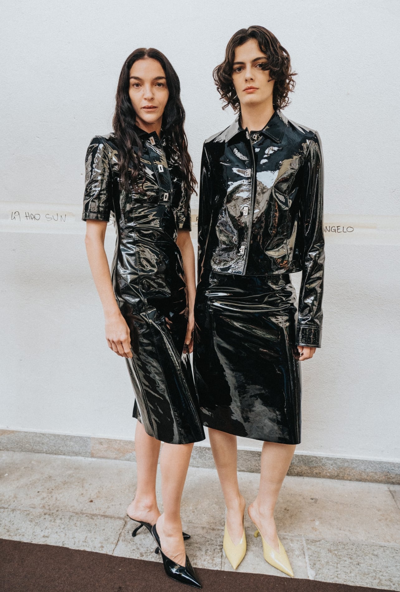 Ferragamo runway models wearing matching shiny black outfits