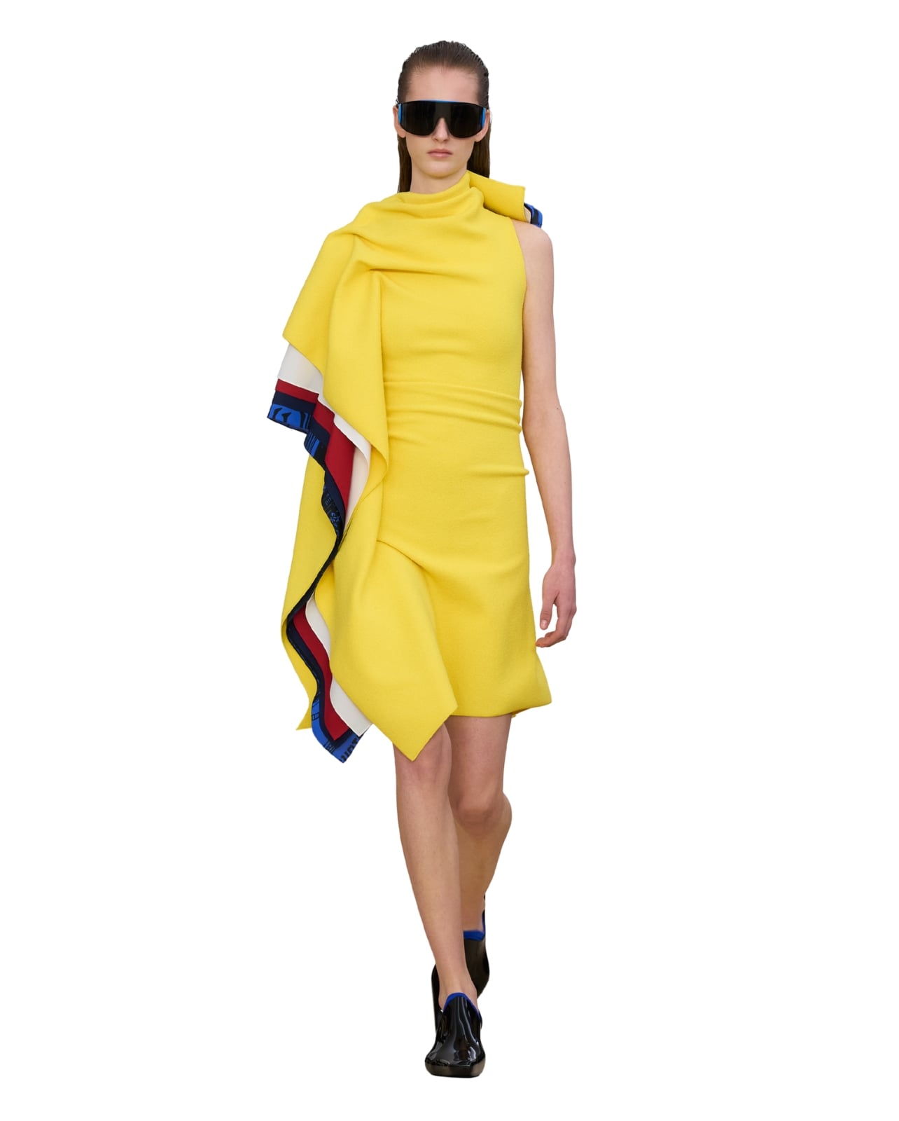 Loewe runway model wearing a yellow ruffle dress with red and blue details