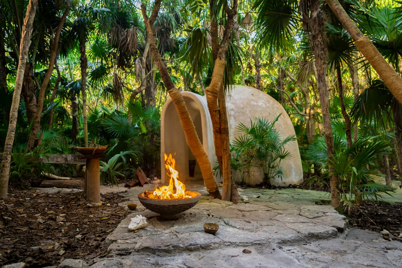 An outdoor firepit near the entrance of a spa