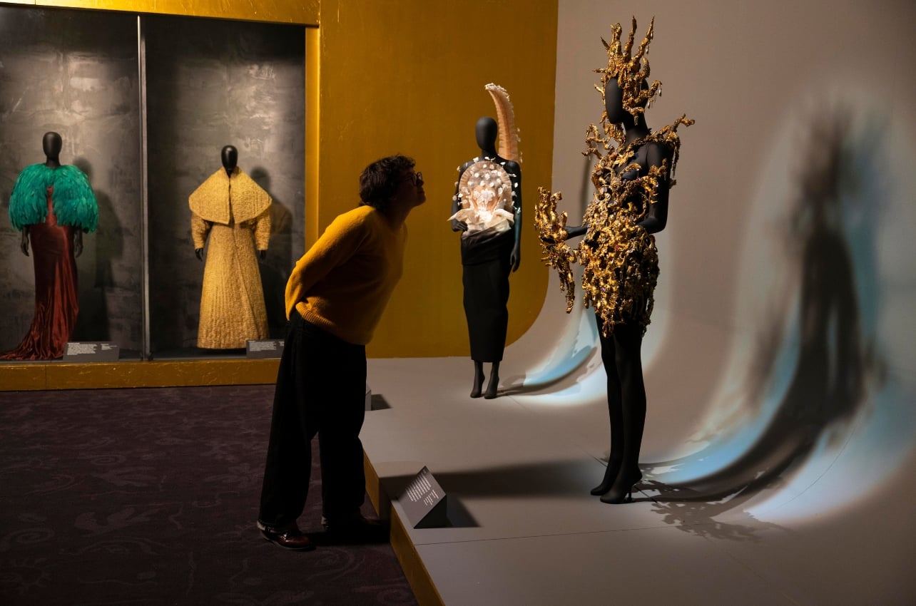 A person looking at a fashion exhibition at the V&A South Kensington