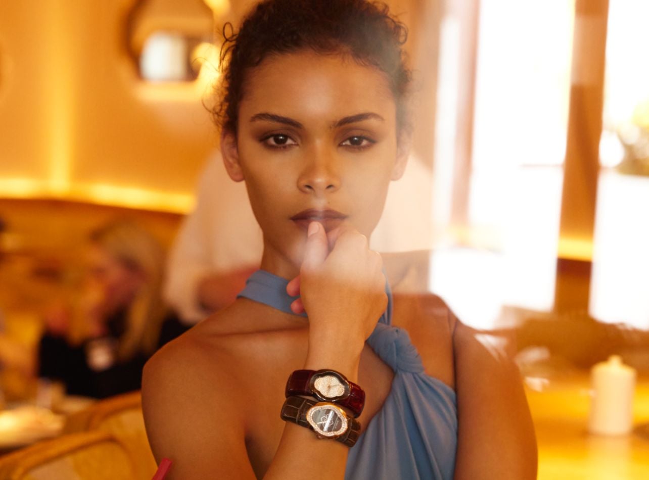 Portrait of model, Madison Hall wearing two watches at a bar setting