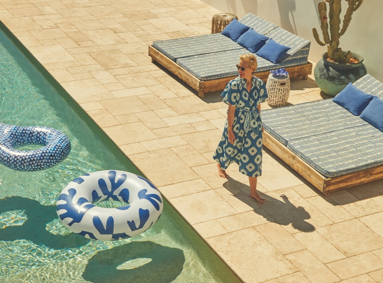 Portrait of Deborah Brett in a floral dress at a pool