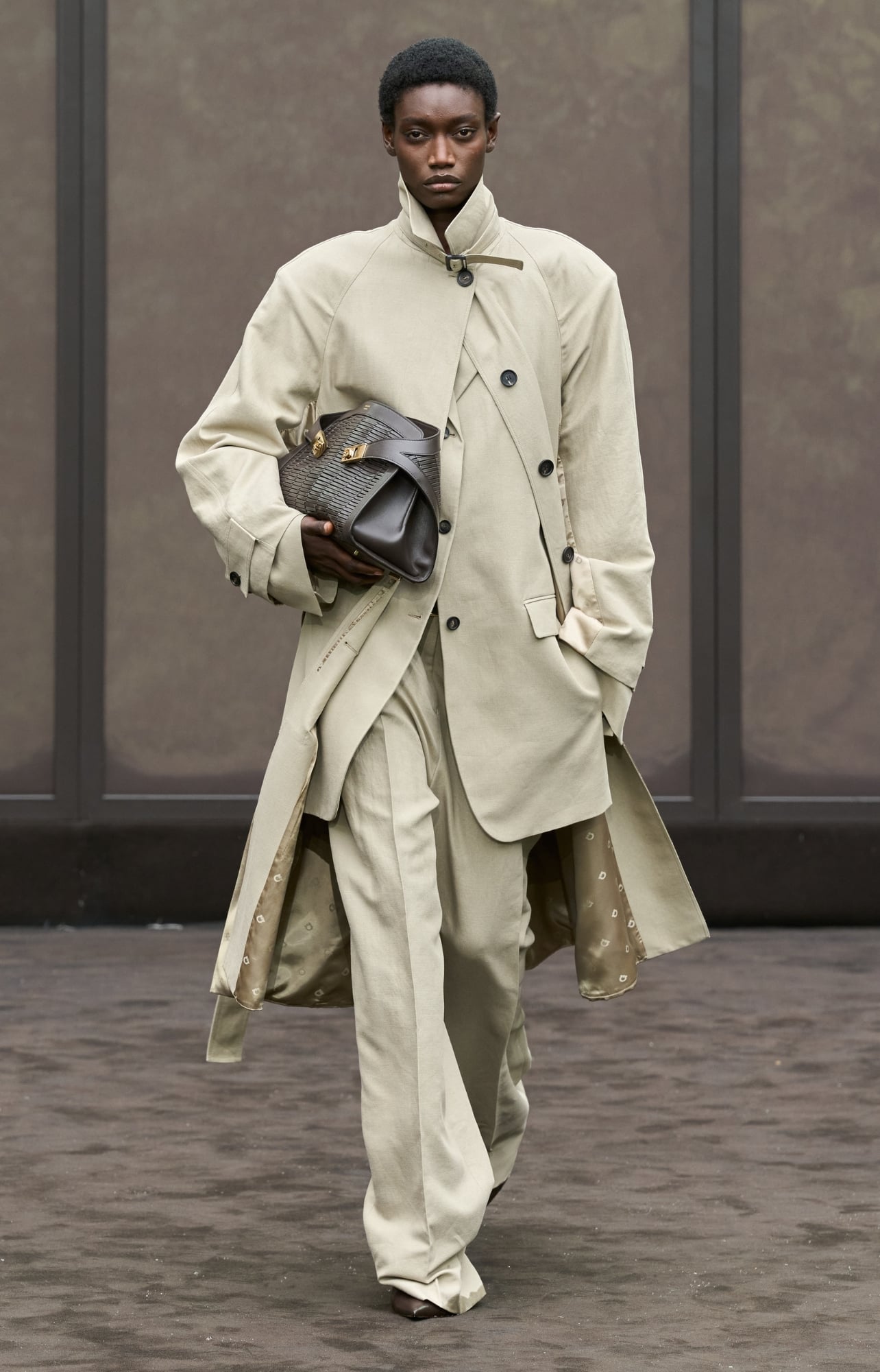 Ferragamo runway model wearing a matching jacket, blazer and pant set in tan
