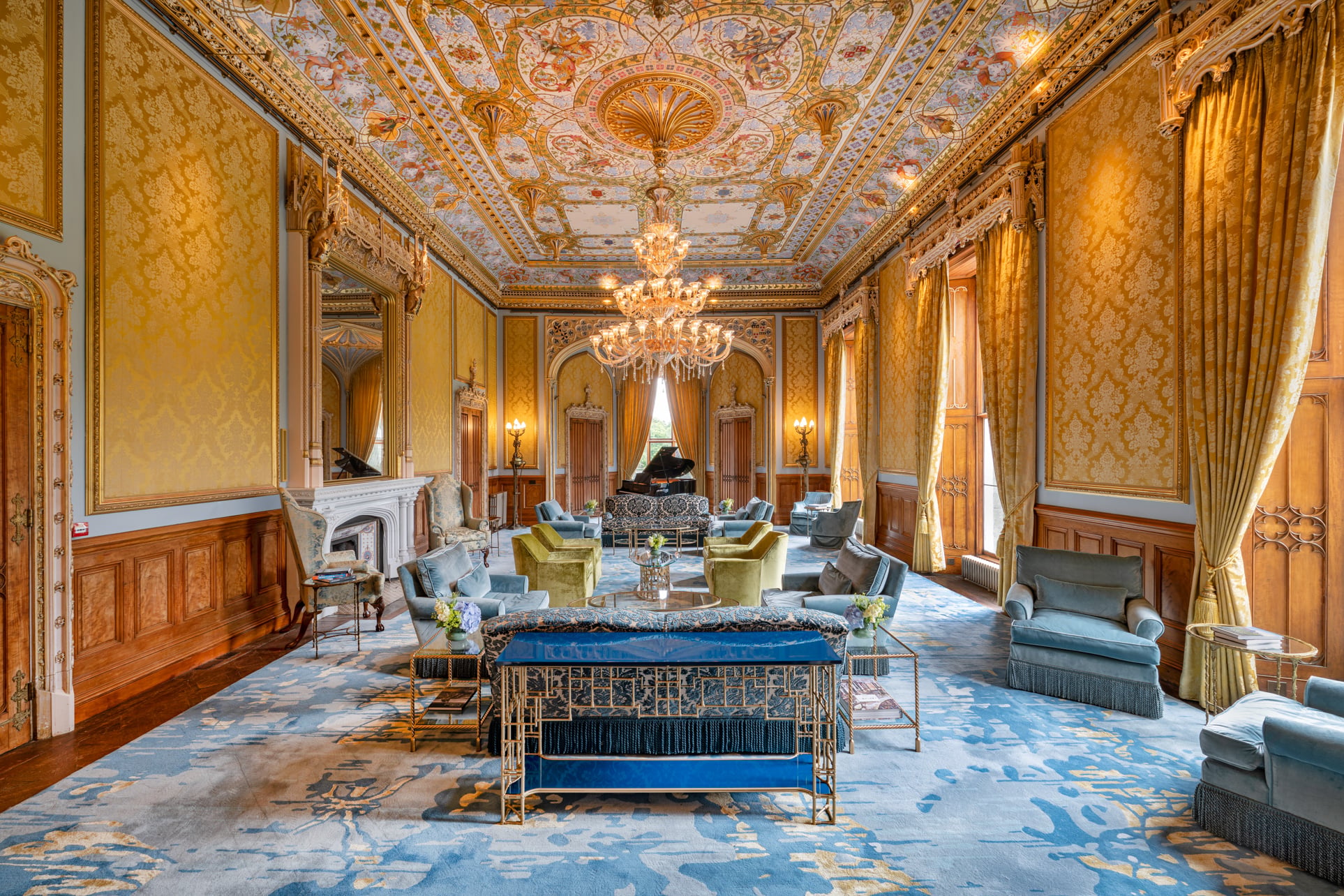 Interior seating area with a big chandelier at Taymouth Castle