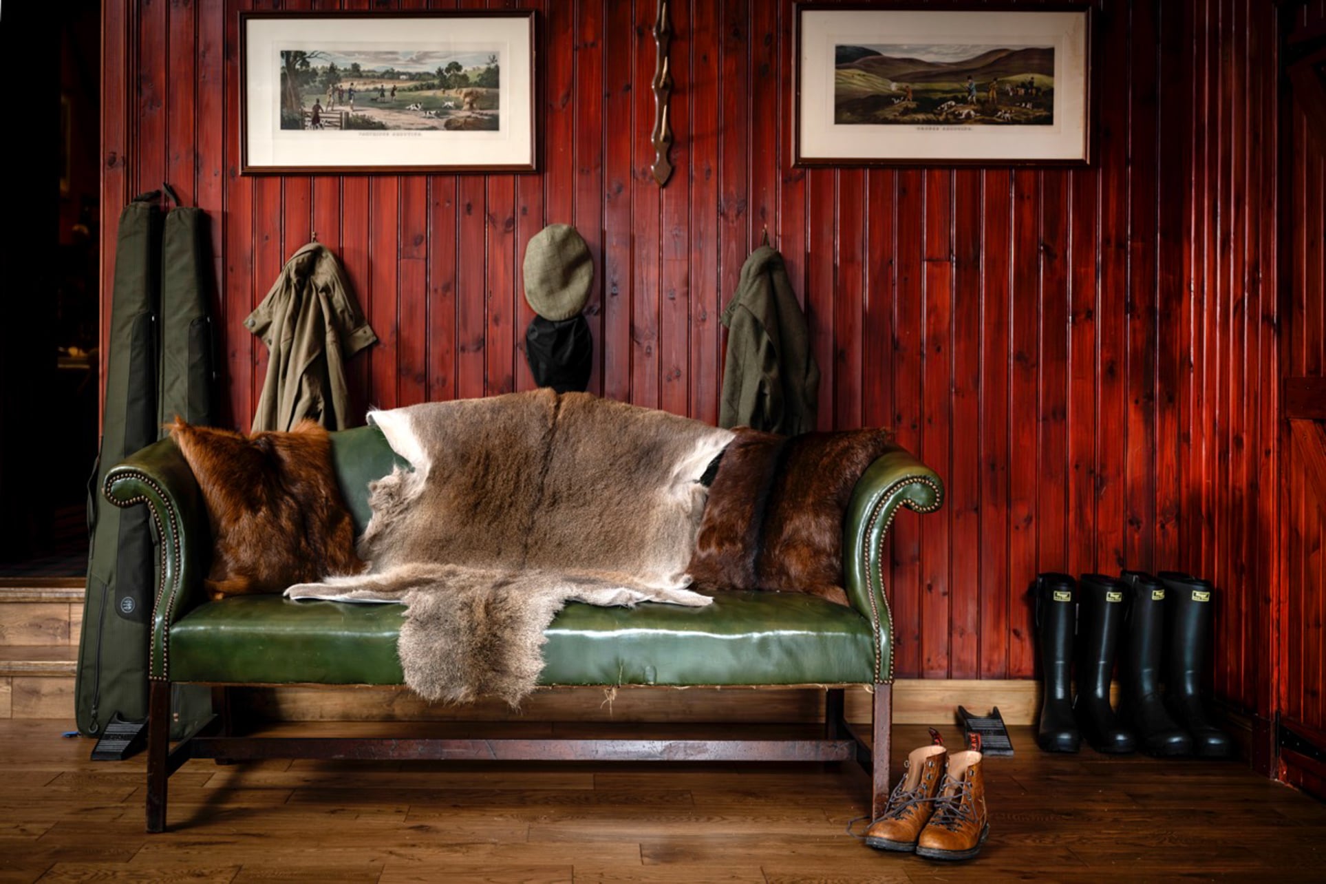 A green couch with a fur throw inside Taymouth Castle