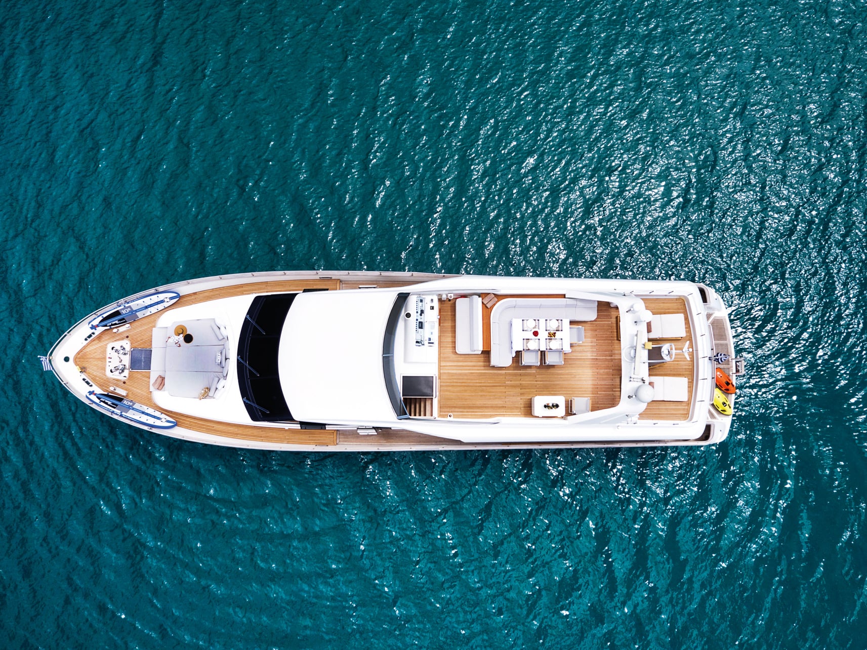 Aerial view of a boat deck with white furniture