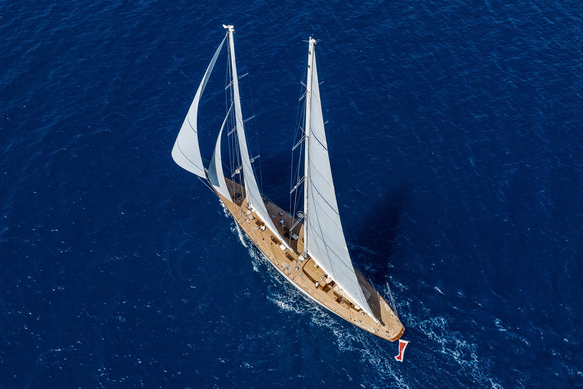 Aerial view of a sailing boat in deep blue water