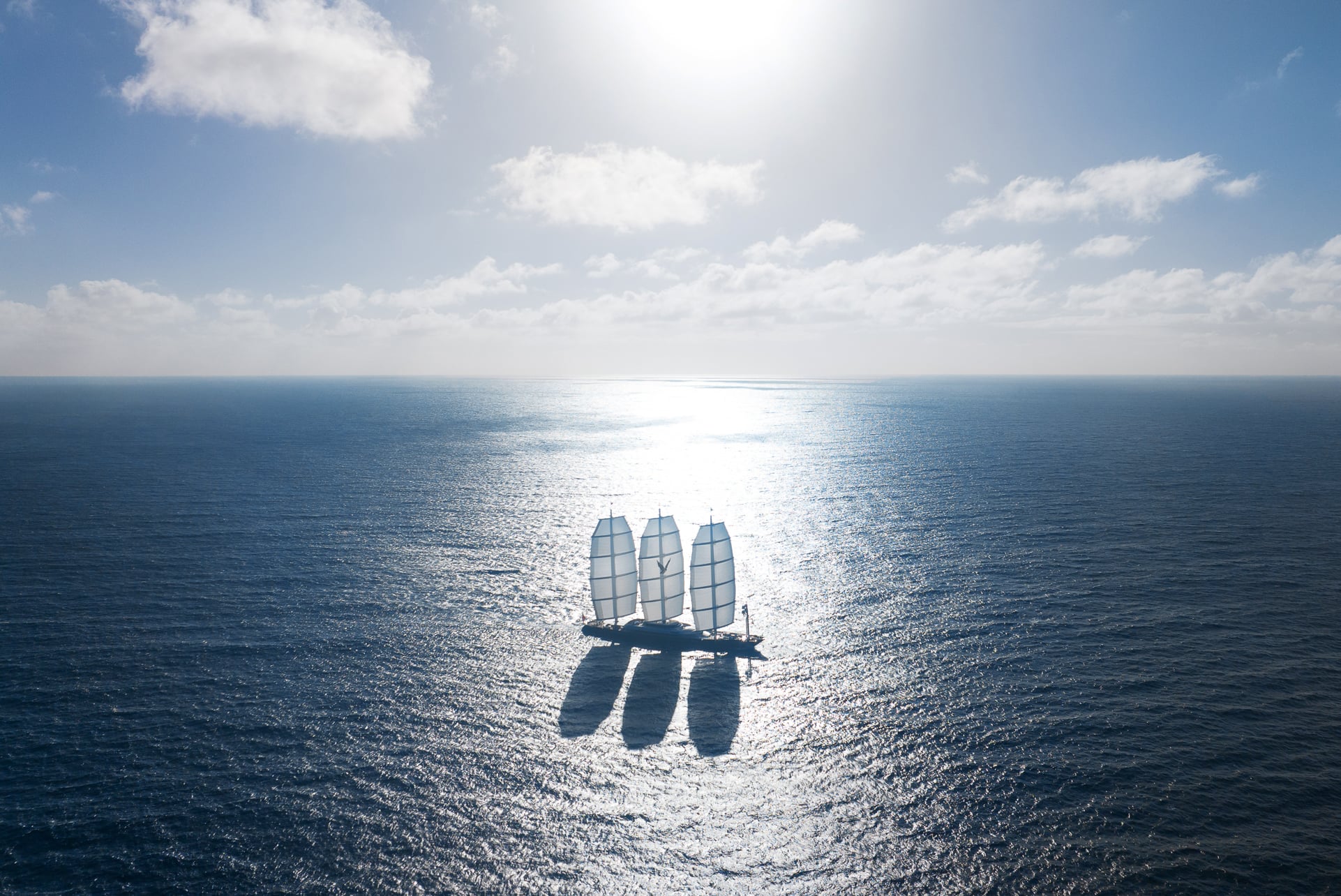 Exterior aerial view of a ship beneath a cloudy sky