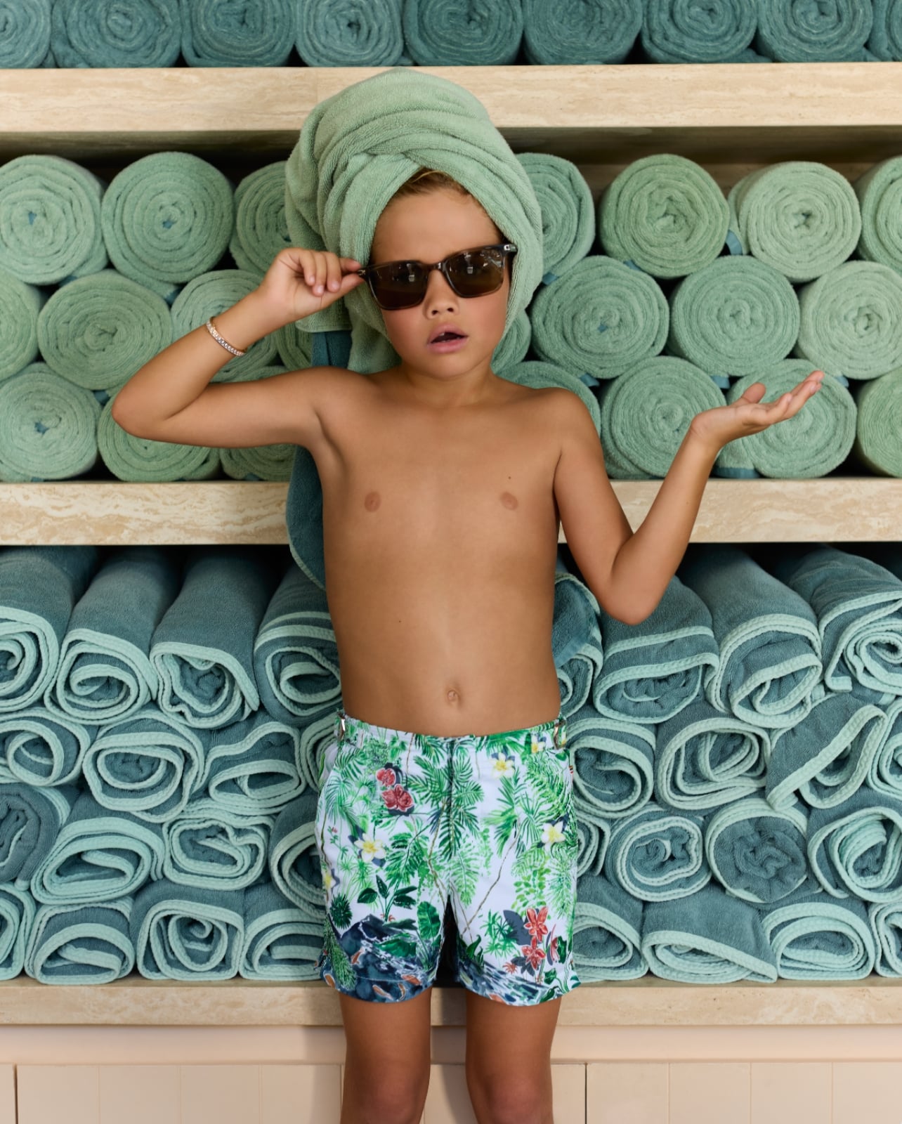 Kid with towel on head and sunglasses