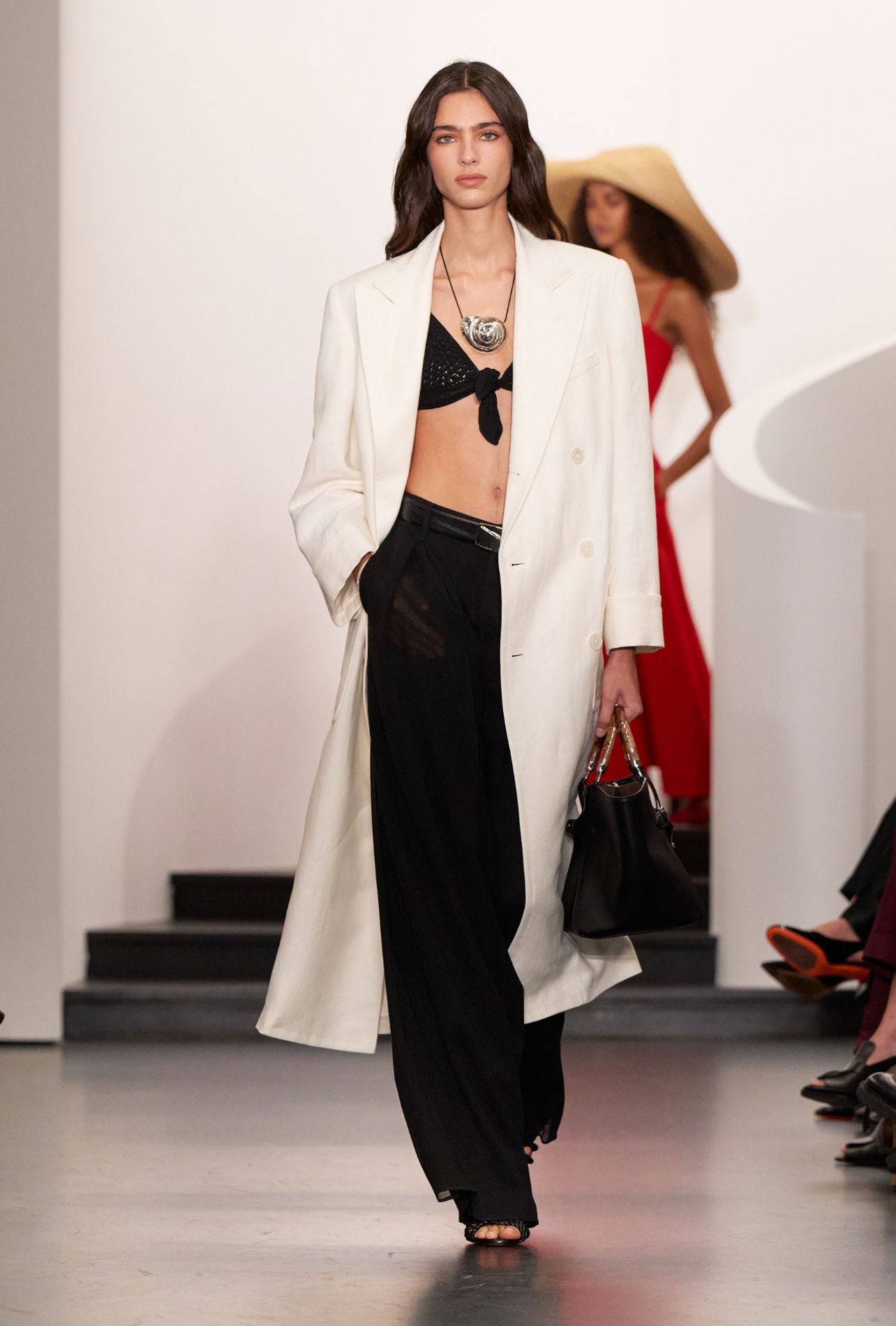 Ralph Lauren runway model wearing a black bralette and white blazer