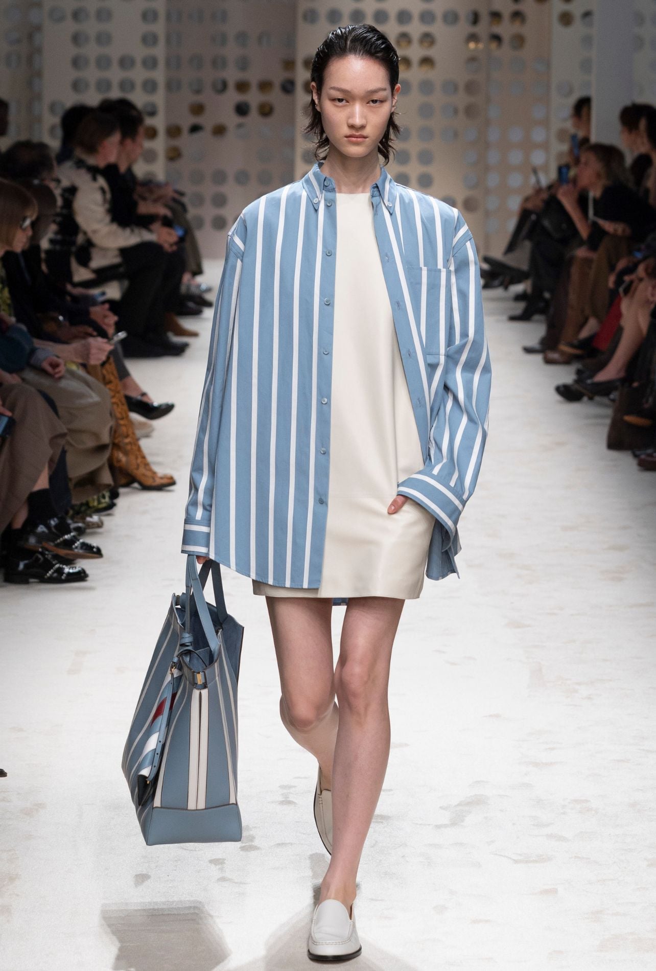 Tod’s runway model wearing a striped button-up top