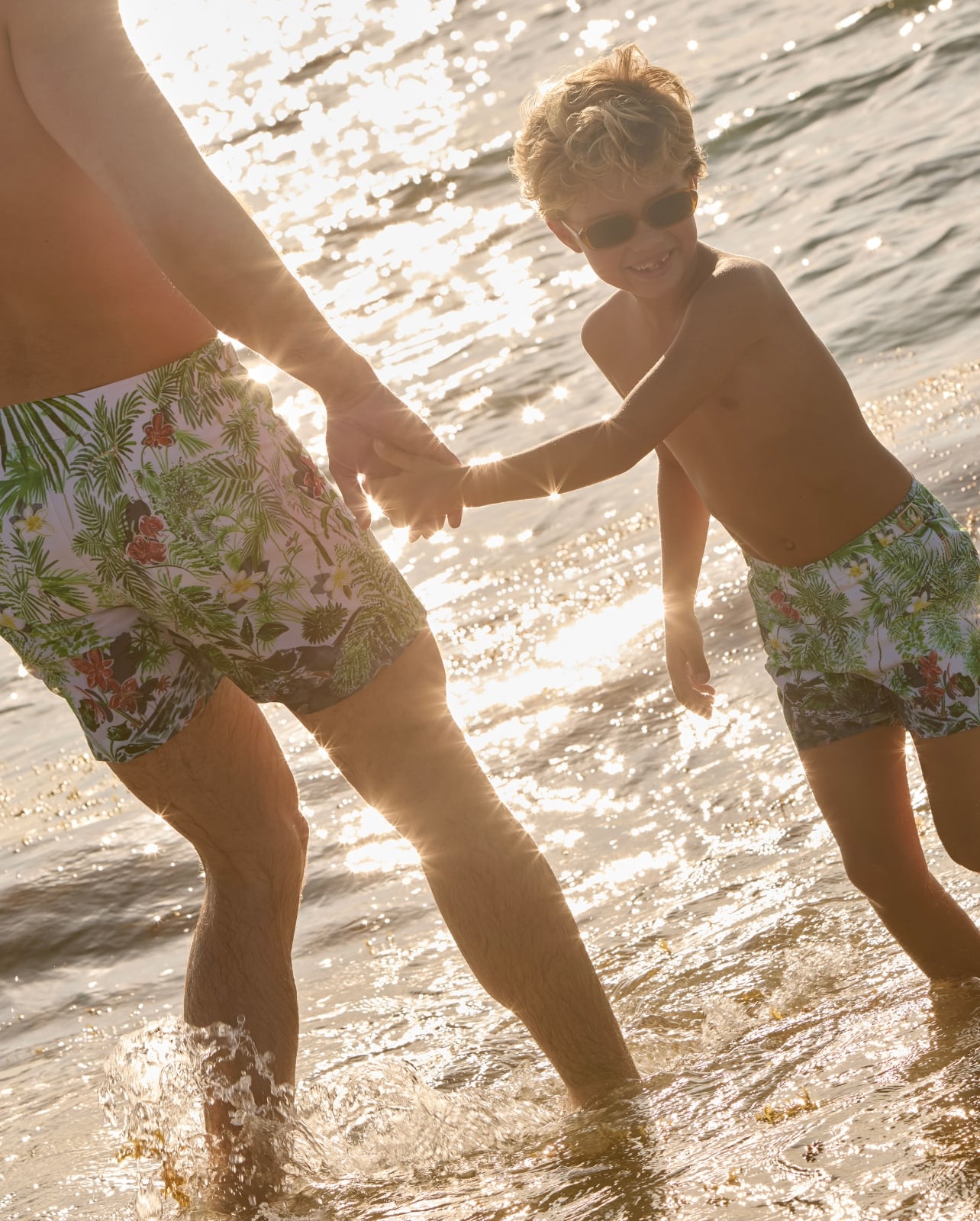 man and child in ocean