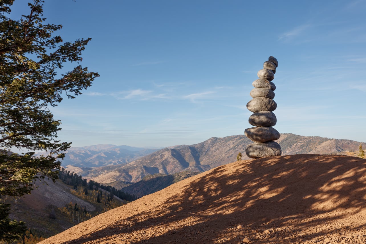 Powder Art installation by Nobuo Sekine featuring stacked rocks on a mountain