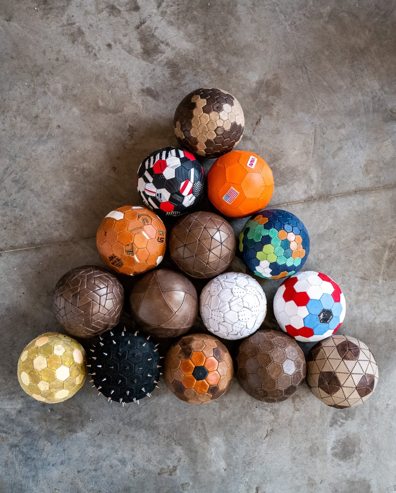 Triangle of various different color socceer balls