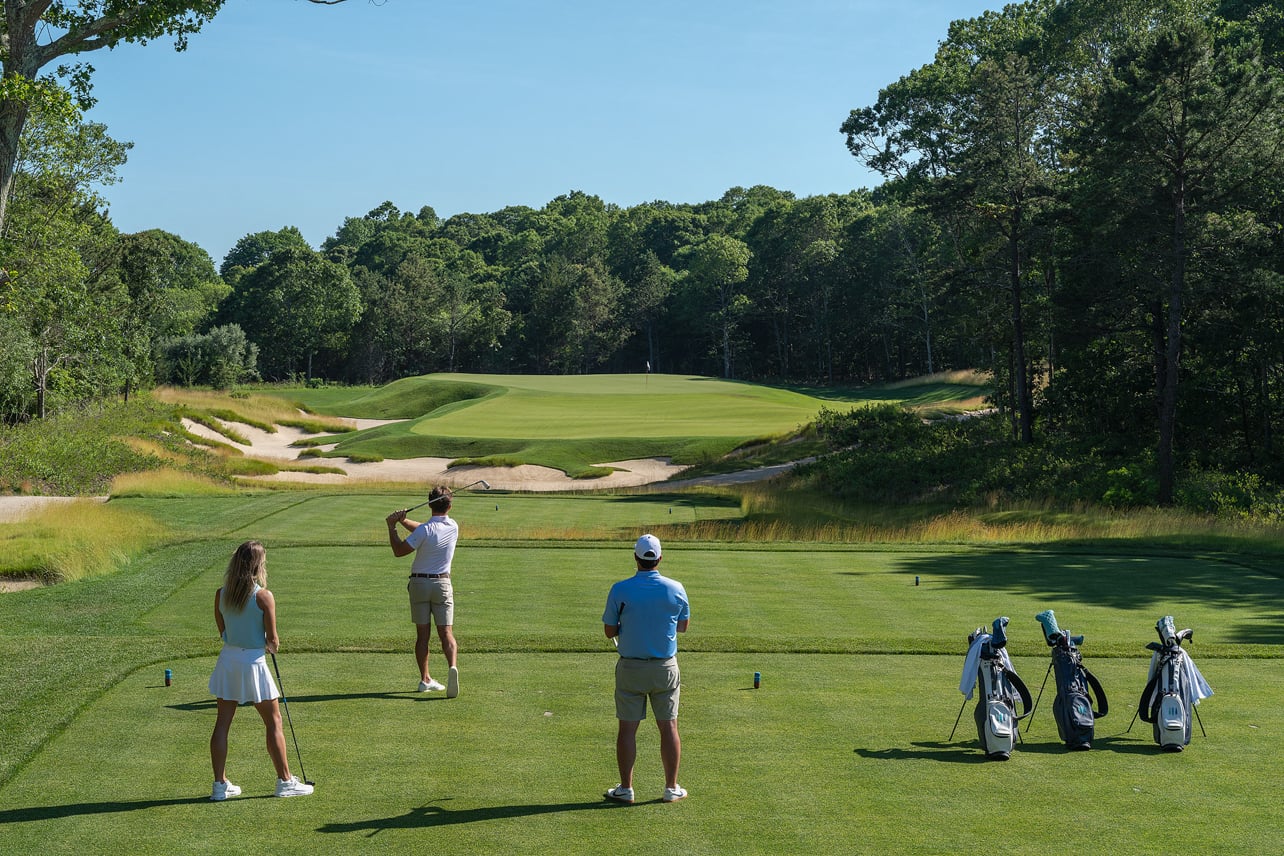 Golfers playing on the course at The Hills