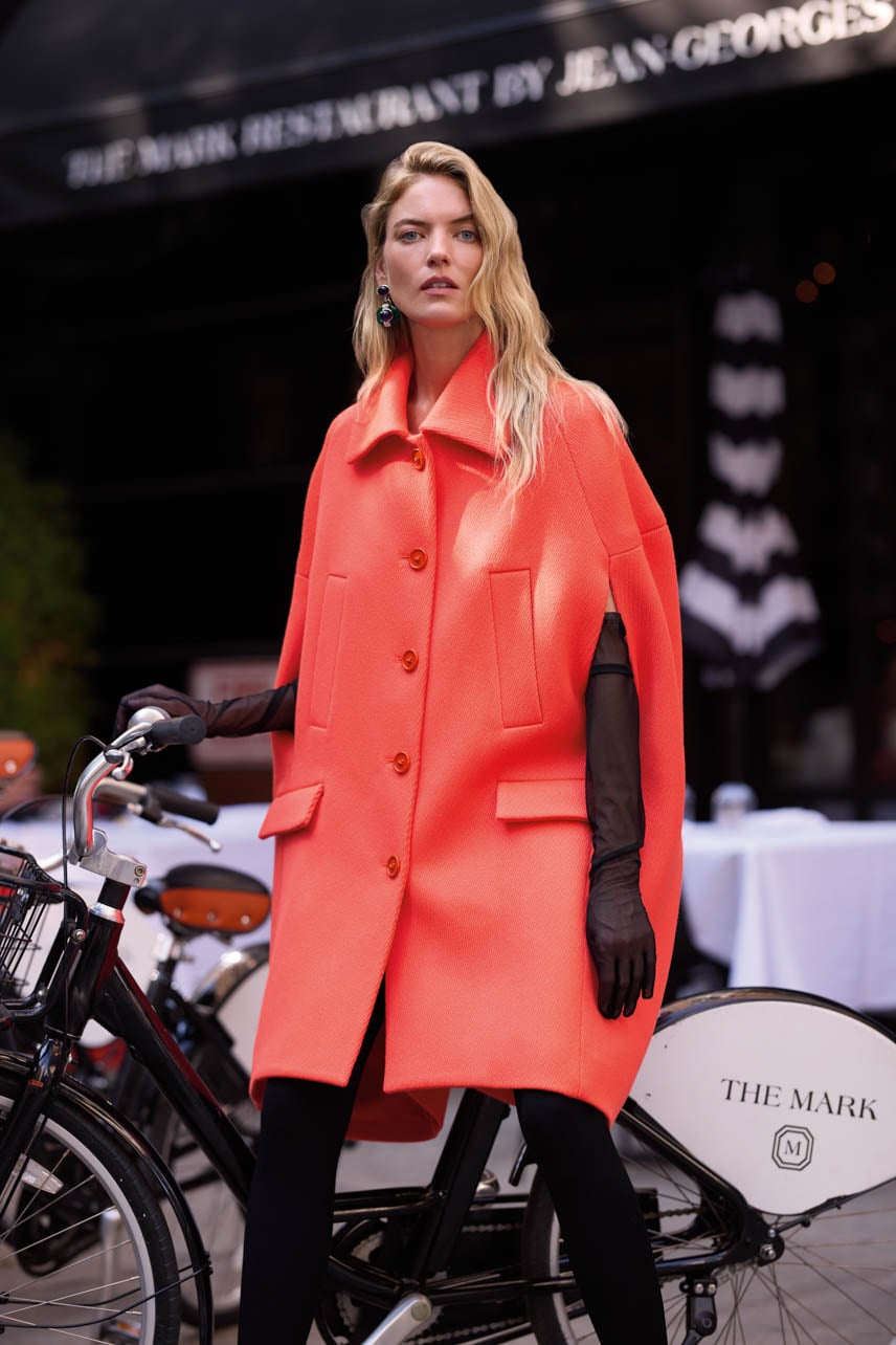 Martha Hunt wearing a red Balenciaga jacket with a bicycle