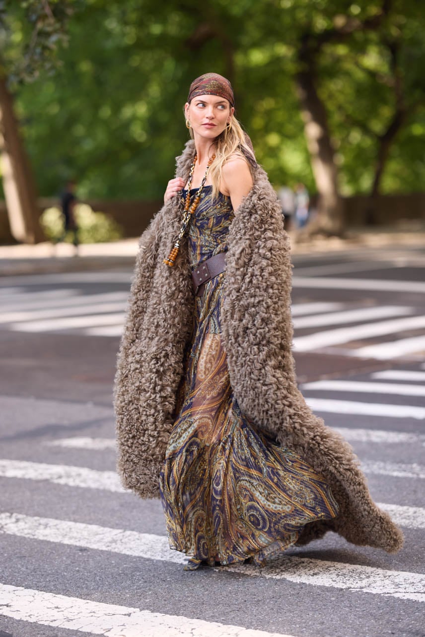 Martha Hunt photographed on the street wearing a long Etro fur jacket