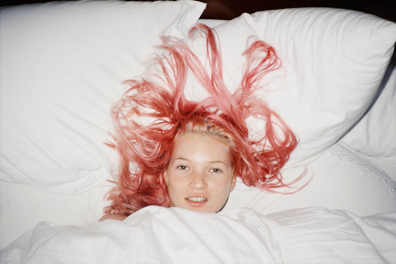 Model, Kate Moss with pink hair covered in white bed sheets