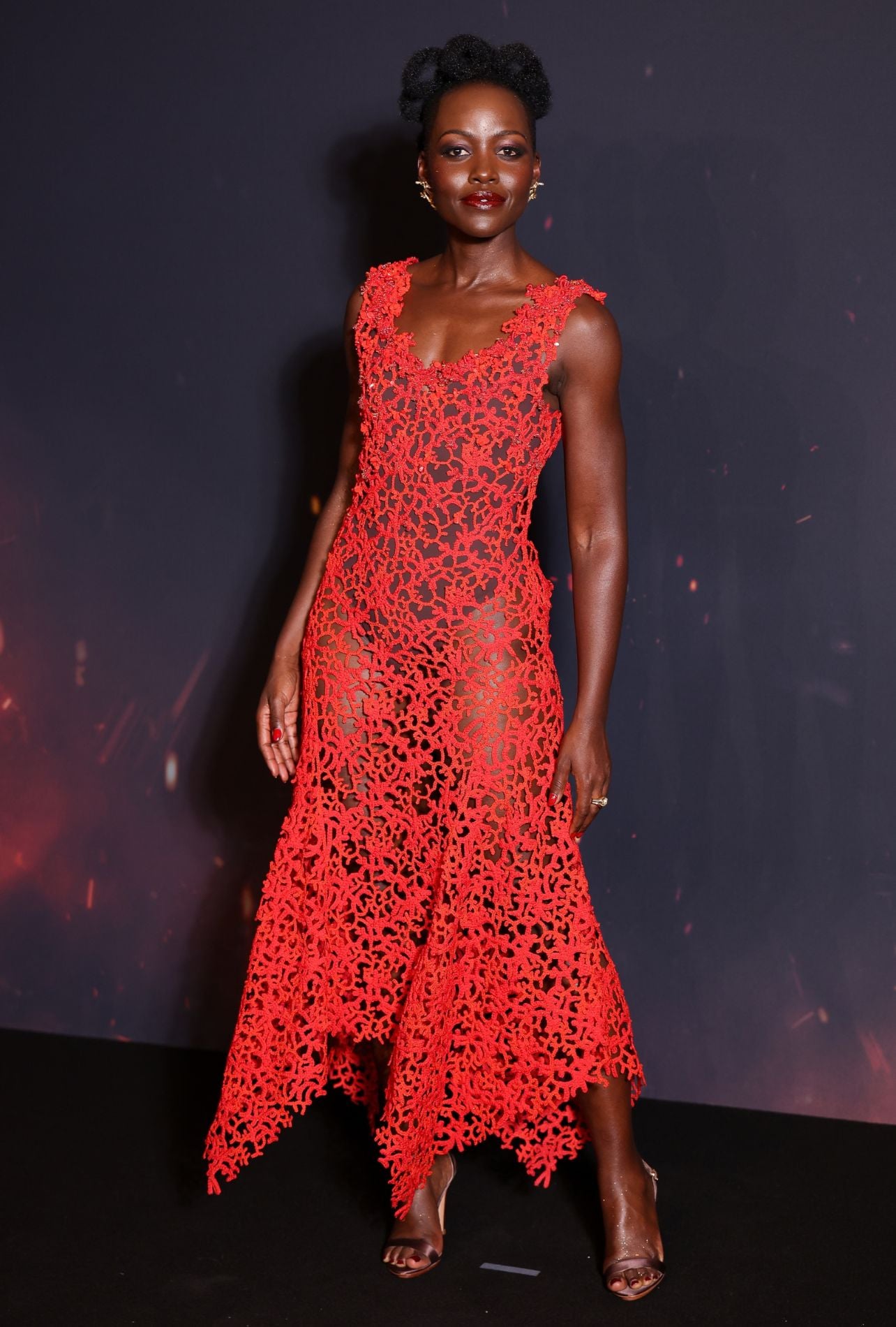 Lupita Nyong’o in a red dress at the Paris premiere of The Odyssey